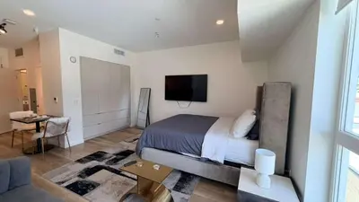 a bedroom with a bed and a flat screen tv at Luxury Walk of Fame Studio in Los Angeles