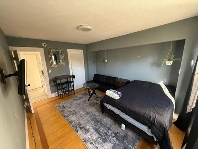 a bedroom with a bed and a couch and a table at Private Room in East Hollywood in Los Angeles