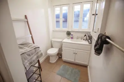 a bathroom with a toilet and a sink and a window at Private Room in East Hollywood in Los Angeles