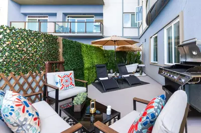 an outdoor patio with chairs and a grill at Ocean 2min, Romantic Bath, Cinema, Pool, Arcade in Marina del Rey