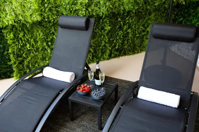 two chairs and a table with two bottles of wine at Ocean 2min, Romantic Bath, Cinema, Pool, Arcade in Marina del Rey