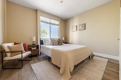 a bedroom with a bed and a chair and a window at 2BD Marina Condo Near Venice Beach, Pool & Free Parking in Los Angeles