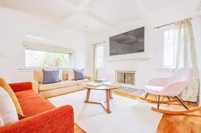 a living room with a couch and a table at Inviting 3BR Home with Porch & Greenery in Los Angeles