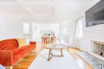 a living room with a couch and a table at Inviting 3BR Home with Porch & Greenery in Los Angeles