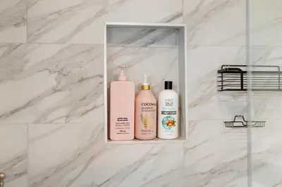 three bottles of bathroom products sitting on a shelf in a bathroom at Bay Breeze Hideaway in Lawndale