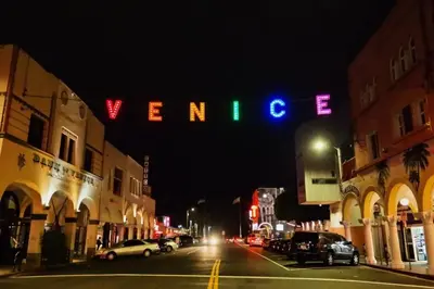 a neon sign that says venice on a city street at night at Exquisite 2BDRM in Heart of MDR King Bed in Los Angeles