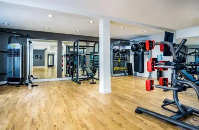 a gym with several tread machines in a room at Exquisite 2BDRM in Heart of MDR King Bed in Los Angeles
