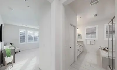 a white bathroom with a sink and a tub at Modern 3BR Home Gated Community in Bakersfield