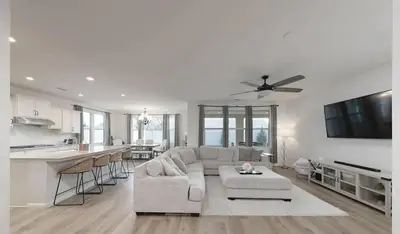 a white living room with a couch and a kitchen at Modern 3BR Home Gated Community in Bakersfield