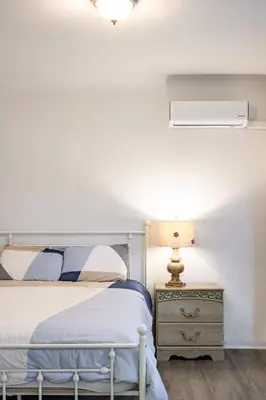 a bedroom with a bed and a lamp on a nightstand at Near LA Cozy Home with Full Kitchen & Laundry in San Gabriel