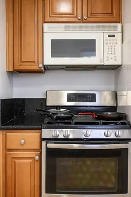 a kitchen with a stove and a microwave at Near LA Cozy Home with Full Kitchen & Laundry in San Gabriel