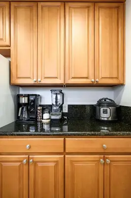 a kitchen with wooden cabinets and a counter top at Near LA Cozy Home with Full Kitchen & Laundry in San Gabriel