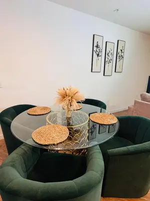 a dining room with a table and two green chairs at The Hollywood loft FREE Parking in Los Angeles