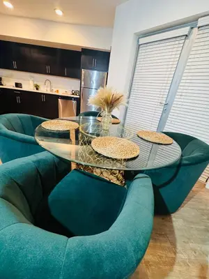 a glass table and chairs in a living room at The Hollywood loft FREE Parking in Los Angeles