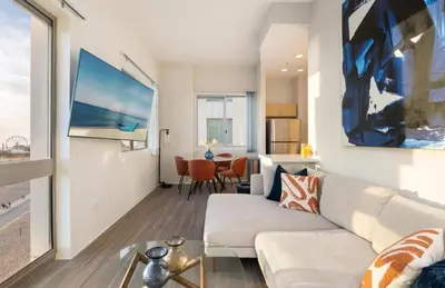 a living room with a couch and a table at The Sunstone - Full Oceanview Right On The Sand in Los Angeles