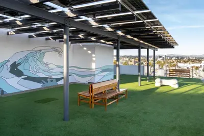 a bench on the roof of a building with a mural at The Sunstone - Full Oceanview Right On The Sand in Los Angeles