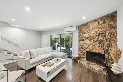 a living room with a couch and a fireplace at Burbank Bliss Retreat in Los Angeles