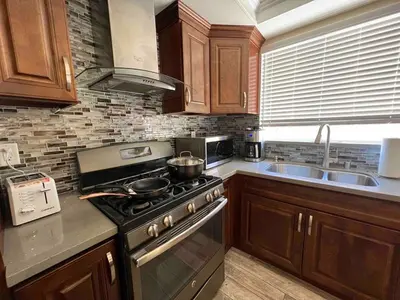 a kitchen with a stove and a sink at Beautiful and cozy! in Palmdale