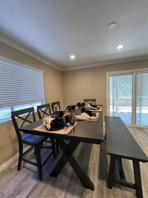 a dining room with a table and chairs and a window at Beautiful and cozy! in Palmdale