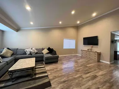 a living room with a couch and a flat screen tv at Beautiful and cozy! in Palmdale