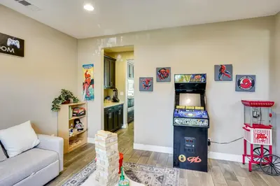 a living room with a video game machine and a couch at 3 Mi to Disneyland Home with Hot Tub and Game Room in Anaheim