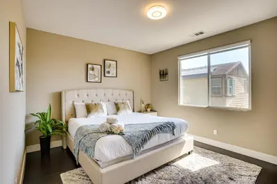 a bedroom with a bed with a teddy bear on it at 3 Mi to Disneyland Home with Hot Tub and Game Room in Anaheim