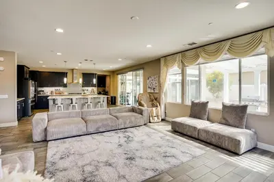 a living room with two couches and a kitchen at 3 Mi to Disneyland Home with Hot Tub and Game Room in Anaheim