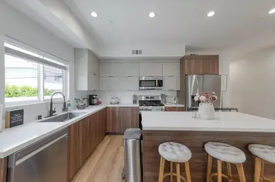 a kitchen with white countertops and wooden cabinets at LA Haven Spacious Townhome in Sherman Oaks Community Hospital Heliport