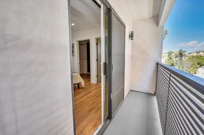 a balcony with a glass door leading into a room at LA Haven Spacious Townhome in Sherman Oaks Community Hospital Heliport