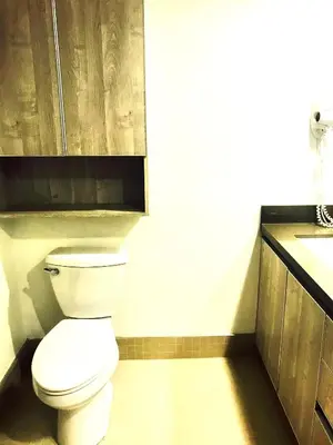 a bathroom with a white toilet and a sink at Western Sierra Vista in Los Angeles