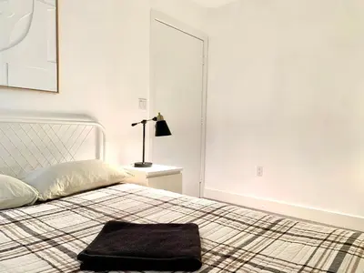 a white bedroom with a bed with a pillow on it at Western Marathon in Los Angeles