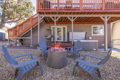 a patio with chairs and a fire pit in front of a house at Moonlight Ridge Jacuzzi, Gated, EV Charge, Cent AC in Big Bear City Airport