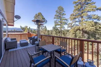 a deck with chairs and a table and a grill at Moonlight Ridge Jacuzzi, Gated, EV Charge, Cent AC in Big Bear City Airport