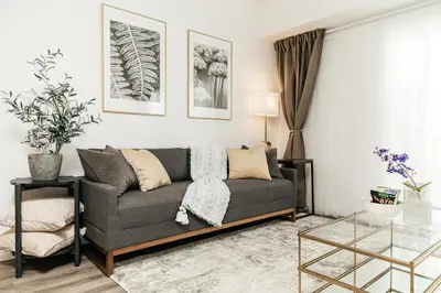 a living room with a gray couch and a glass table at Cozy 2BD apartment in Los Angeles