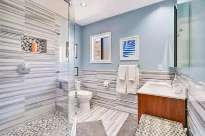 a bathroom with a toilet and a sink at Modern Pool house with hot tub and relaxing backyard in Long Beach
