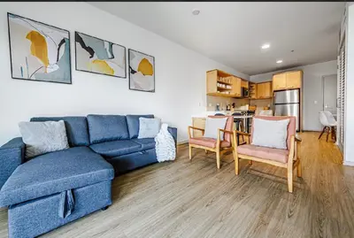 a living room with a blue couch and chairs at Beautiful Apartment in Hollywood in Los Angeles