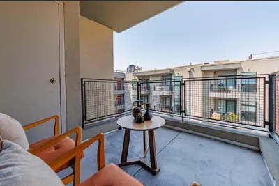 a balcony with a table and a view of a building at Beautiful Apartment in Hollywood in Los Angeles