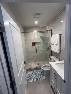 a bathroom with a shower and a toilet and a sink at Guest House in Torrance