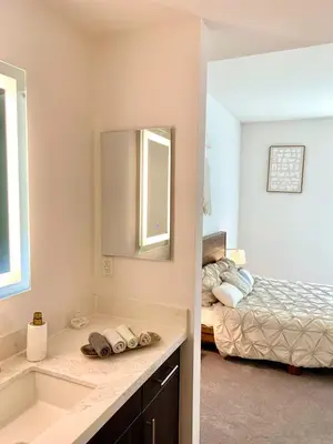 a bathroom with a sink and a bedroom with a bed at Luxury Hollywood Stay Beautiful 2Beds2Baths in Los Angeles