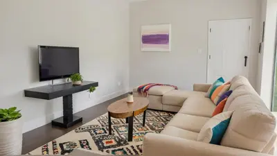 a living room with a couch and a tv at Modern Boutique Living in Culver City in Los Angeles