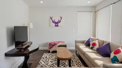 a living room with a couch and a tv at Modern Boutique Living in Culver City in Los Angeles