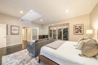 a bedroom with a large bed and a couch at Spacious Hollywood Private Villa with 7 Bedrooms and Pool in Los Angeles