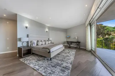 a bedroom with a bed and a large window at Spacious Hollywood Private Villa with 7 Bedrooms and Pool in Los Angeles