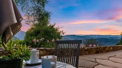 a chair sitting at a table with a view of mountains at Malibu Hills Studio w Mountain Views Near beaches Cielo Nook by AvantStay in Malibu Beach