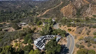 an aerial view of a house on a hill with a road at Malibu Hills Studio w Mountain Views Near beaches Cielo Nook by AvantStay in Malibu Beach