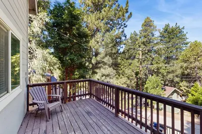 a wooden deck with a bench on a house at 7 Mi to Snow Valley Mountain Resort Quiet Cabin in Running Springs