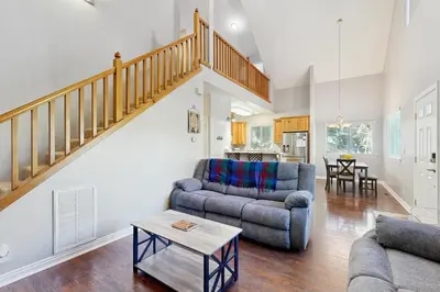 a living room with two couches and a staircase at 7 Mi to Snow Valley Mountain Resort Quiet Cabin in Running Springs