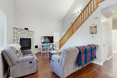 a living room with two chairs and a fireplace at 7 Mi to Snow Valley Mountain Resort Quiet Cabin in Running Springs
