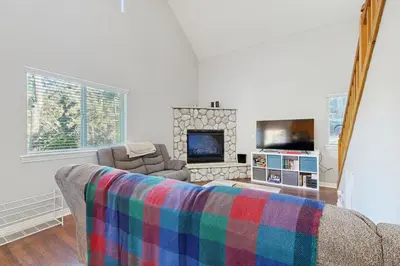 a living room with a couch and a fireplace at 7 Mi to Snow Valley Mountain Resort Quiet Cabin in Running Springs
