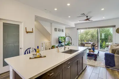 a kitchen with a sink and a living room at 2 Mi to Cabrillo Beach Luxe LA Gem with Balcony in San Pedro